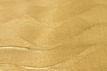 golden color painted art background texture selective focusの写真素材