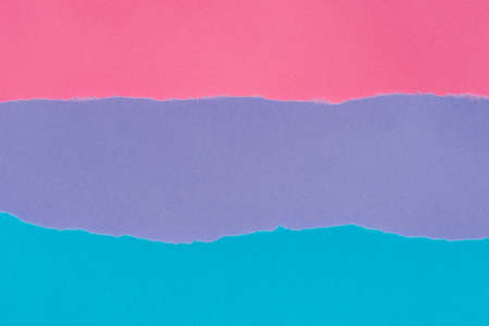 colorful pieces of torn paper background texture: blue, violet, pink colors