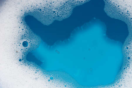 soap foam an bubbles on water background selective focus
