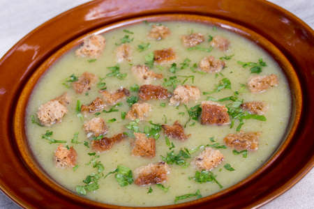 vegetable cream soup with croutons and parsleyb