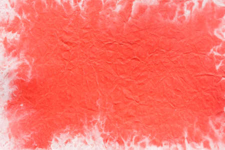 red watercolor painted on old  creased paper background textureの写真素材