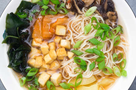 vegan ramen soup with noodle, mushrooms, tofu and vegetables
