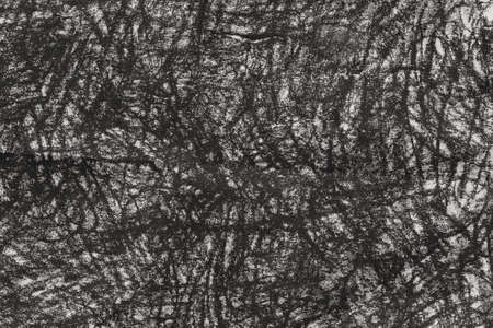 black charcoal doodles on gray paper background textureの写真素材
