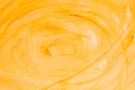 yellow painted watercolor background on paper textureの写真素材