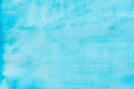 blue painted watercolor on paper background textureの写真素材