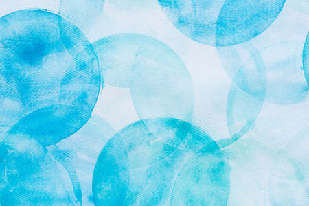 blue painted watercolor circles on paper background textureの写真素材