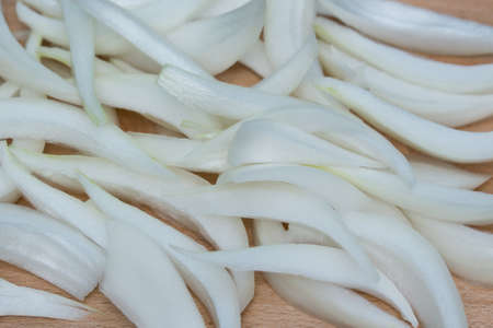 chopped onion on wooden board closeup selective focus