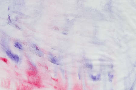 pink and violet watercolor painted background on paper textureの写真素材