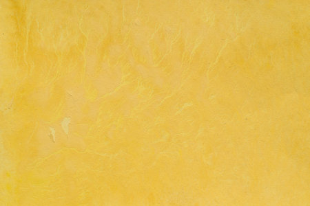 yellow painted watercolor on paper background textureの写真素材