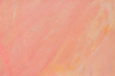 pale orange pink watercolor on paper background textureの写真素材
