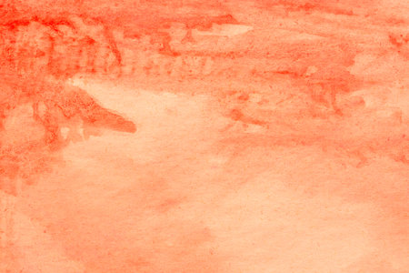 orange painted watercolor background on paper textureの写真素材