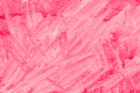 red watercolor painted background on paper textureの写真素材