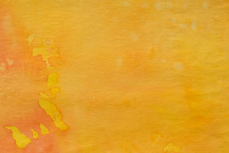 yellow watercolor painted background on paper textureの写真素材