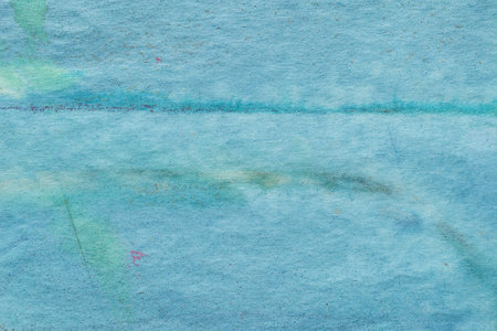 Blue painted watercolor background on paper textureの写真素材