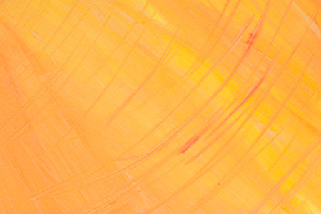 orange color painted background on paper textureの写真素材