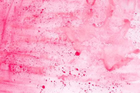 red and pink painted watercolor background on paper textureの写真素材