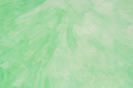 green painted watercolor background on paper textureの写真素材