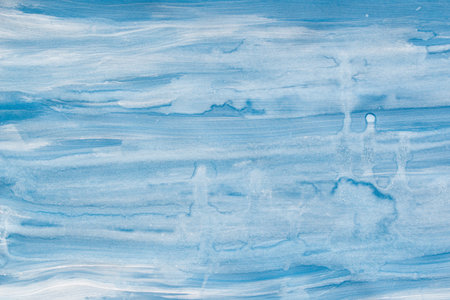 blue painted watercolor background on paper textureの写真素材