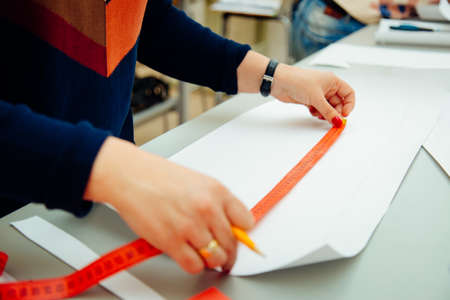 Women's hands at work for designing and making pattern
