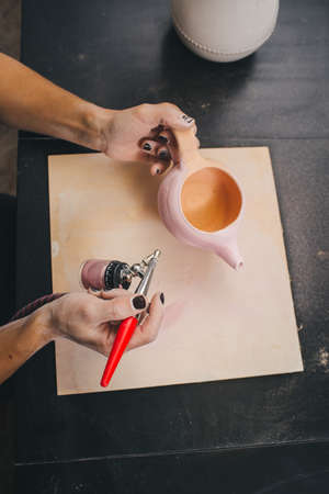 Female Potter creating pot and decor it