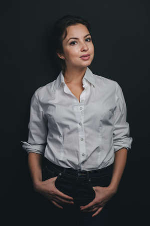 Young Brunette woman posing against blackの写真素材