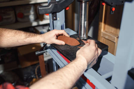 Close up of hands tanner performs work on table with toolsの写真素材