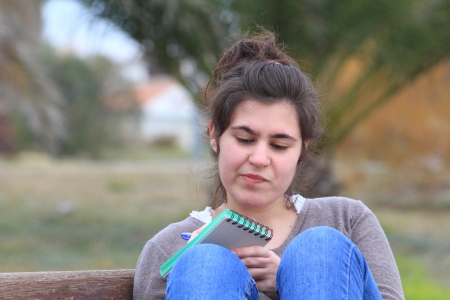 Young girl writing in a campus, outdoorsの写真素材