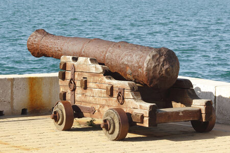 Old cannon pointing at the seaの写真素材