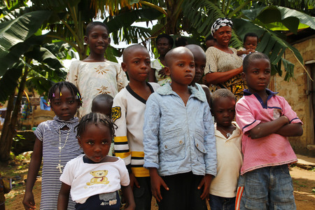 AKURE, NIGERIA - AUGUST 12, 2012  Nigerian boys and girls  stand up for a portrait in a local village at  Ondo state in Nigeria, on August 12, 2012のeditorial素材