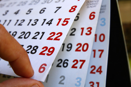 Calendar with open pages, with human fingersの写真素材