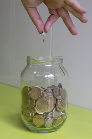 Hand with a coin,  for savingsの写真素材