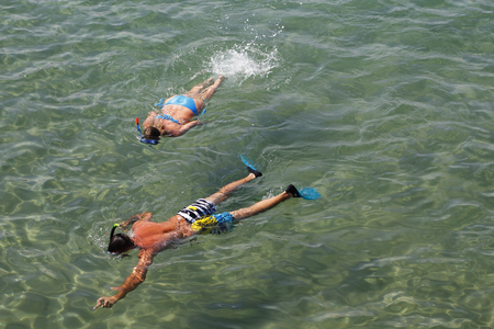 Couple snorkeling in transparent waterの写真素材