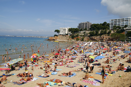 SALOU, SPAIN - JUNE 22: People relaxing and having fun on the beach to have their holidays on June 22, 2014 at the coast of Salou, Spain, a famous tourist destinationのeditorial素材