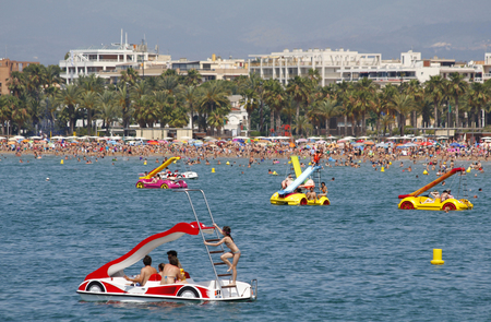SALOU, SPAIN - JUNE 22: People relaxing and having fun on the beach to have their holidays on June 22, 2014 at the coast of Salou, Spain, a famous tourist destinationのeditorial素材