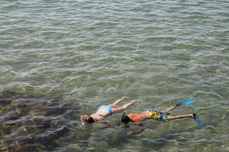 Couple snorkeling in transparent waterの写真素材