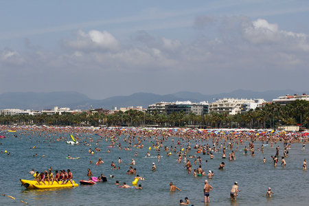 SALOU, SPAIN - JUNE 22  People relaxing and having fun on the beach to have their holidays on June 22, 2014 at the coast of Salou, Spain, a famous tourist destinationのeditorial素材
