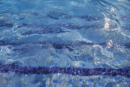Pool water with sun reflections