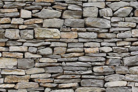 Stone wall background, traditional construction wayの写真素材
