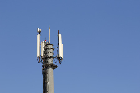 Mobile antenna in a tower against blue skyの写真素材