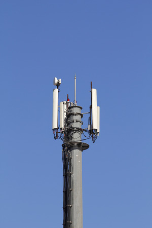 Mobile antenna in a tower against blue skyの写真素材