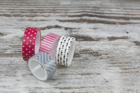 Washi tape rolls, in a wood backgroundの写真素材