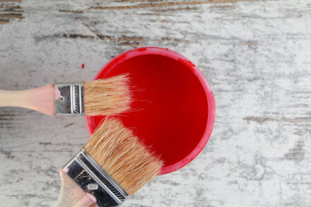 Paintbrushes and paint can in a wood background, vintageの写真素材