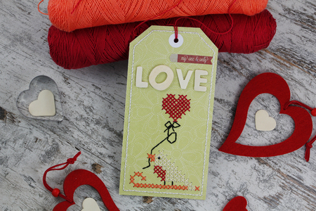 Handmade tag with cross stitchの写真素材