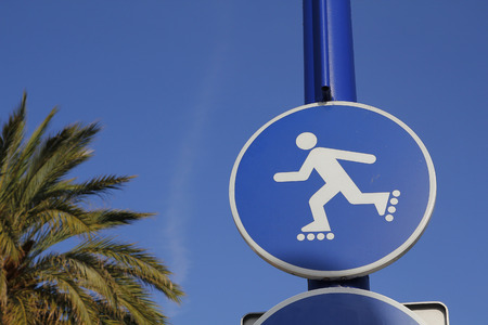 Rollerblade blue sign, in a public parkの写真素材