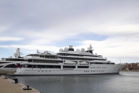 Large yacht with helicopter, moored on harborの写真素材