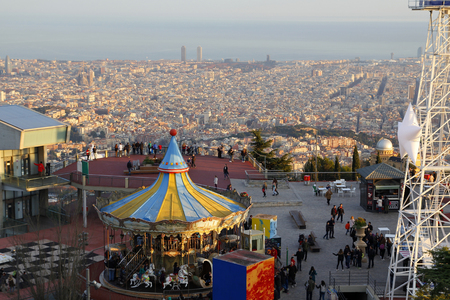 BARCELONA, SPAIN - DECEMBER 28, 2015. Tibidabo amusement park, with people having fun in the top of the city of Barcelona, Spain, on December 28, 2015のeditorial素材