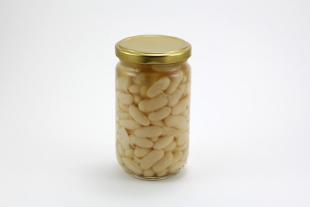 Canned beans in a glass jar, isolated in a white backgroundの写真素材