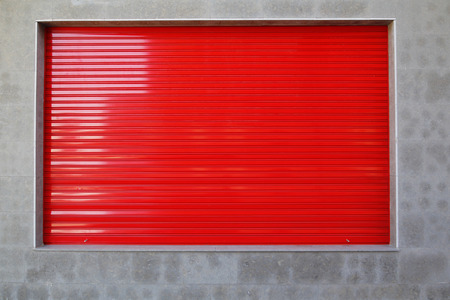 Store front closed, with red metallic blind in the showcaseの写真素材