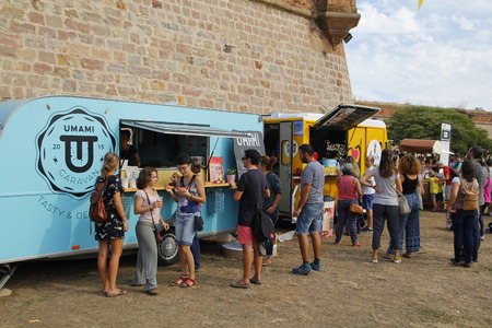 BARCELONA, SPAIN - SEPTEMBER 25, 2016: People around Montjuic castle in the city of Barcelona, for a city festival with different food trucksのeditorial素材