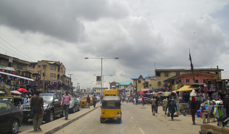 LAGOS, NIGERIA - MAY 11, 2012: People in the street in the city view of Lagos, the largest city in Nigeria and the African continent. Lagos is one of the fastest growing cities in the world